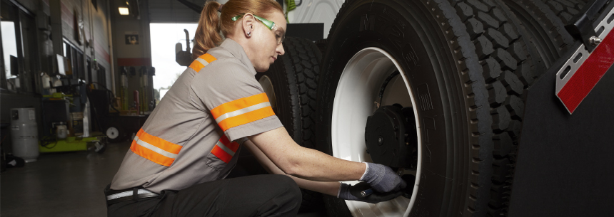 Female Mechanic Changing a Tire